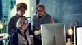 Working late and still working hard. a group of businesspeople working late in an office. Royalty Free Stock Photo