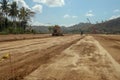 Working machines and heavy equipment adjust the terrain of the race track. Construction of the area and the Moto GP Mandalika