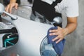 Working man cleaning headlight motorcycle Royalty Free Stock Photo