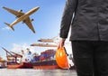 working man and commercial ship on port and air cargo plane flying above use for water and air transport,logistic import export i Royalty Free Stock Photo