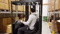 A working man moving cartons with fork lift truck in warehouse/store. Industrial. Transportation concept,