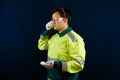 A working man puts on earplugs. Hearing and vision protection equipment. A worker wearing protective gloves, goggles and earplugs Royalty Free Stock Photo