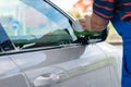 Working man washes car rear view mirror Royalty Free Stock Photo