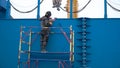 Working man welding steel frame site construction. Clip. Man in the mask makes welding structures on the construction Royalty Free Stock Photo