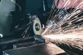 The working mechanic cleans the metal by grinding Royalty Free Stock Photo