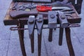 Working metal tools in blacksmith`s workshop, close-up, selective focus, toned