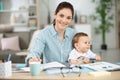 working mom with baby in lap Royalty Free Stock Photo