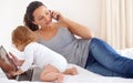 Working, mom and phone call with baby on laptop multitasking in home. Infant, kid and mother busy with computer and Royalty Free Stock Photo