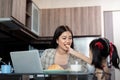 Working mom work from home office. Happy mother and daughter feed snacks to each other. businesswoman and cute child Royalty Free Stock Photo