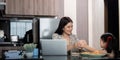 Working mom work from home office. Happy mother and daughter feed snacks to each other. businesswoman and cute child Royalty Free Stock Photo