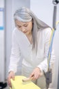 Woman diligently cleaning clothes with brush