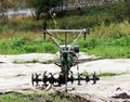 working motor-cultivator tiller in Gatchina park is on the ground waiting for work. Royalty Free Stock Photo