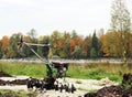 working motor-cultivator tiller in Gatchina park is on the ground waiting for work. Royalty Free Stock Photo