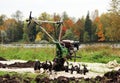 working motor-cultivator tiller in Gatchina park is on the ground waiting for work. Royalty Free Stock Photo