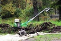 working motor-cultivator tiller in Gatchina park is on the ground waiting for work. Royalty Free Stock Photo