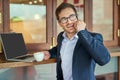 Working from my favourite cafe. a young businessman making a phonecall while sitting in a coffee shop. Royalty Free Stock Photo