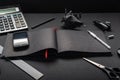 Working office desk with black stationery. Opened black journal for notes. View of the table at an angle. Royalty Free Stock Photo