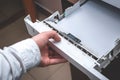 Working With An Office Printer: Male Hand Closes The Printer`s Paper Tray. Loading Paper In The Tray. Side View