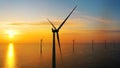 Working offshore wind farm, sunset view. Aerial view of Windpark with wind turbines, windmills. Royalty Free Stock Photo