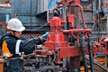 A working oil driller is engaged in spinning pump pressuring pip