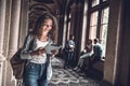 Working online. Beautiful female student preparing to lessons on digital tablet Royalty Free Stock Photo