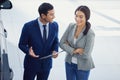 Working out a payment plan. a handsome young male car salesman talking to a female customer on the showroom floor. Royalty Free Stock Photo