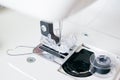 working part of a home sewing machine for handicrafts. Selective focus on plastic shuttle and sewing needle. Close-up Royalty Free Stock Photo