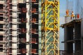 Working people build high-rise building Royalty Free Stock Photo