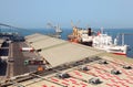 Working people ship cargo boats at port