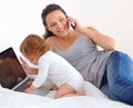 Working, phone call and mom with baby on laptop multitasking in home. Infant, kid and mother busy with computer and Royalty Free Stock Photo