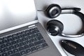 Working place with laptop, headphones and computer mouse on white office desk Royalty Free Stock Photo