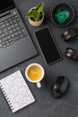 Working place and office desk with coffee, laptop, headset and smartphone