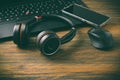 Working place and office desk with laptop, headset, smartphone and computer mouse Royalty Free Stock Photo