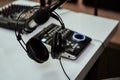 Working place of radio host. Close up of headphones, microphone and sound mixing desk on the table in recording studio Royalty Free Stock Photo