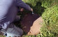 A working plumber opening septic system tank. Copy space for text Royalty Free Stock Photo