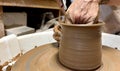 Working with a potter's wheel master class female hands Show how to make an object out of clay Also leveling with a Royalty Free Stock Photo