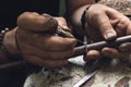 Working process, a jeweler is engaged in the repair of a gold ring with a precious stone in the workshop