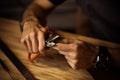 Working process of the leather belt in the leather workshop. Man holding crafting tool and working. Tanner in old