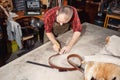 Working process in the leather workshop. Tanner in old tannery.