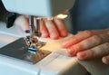 Working process of a tailor. Craftsperson sews with a sewing machine Royalty Free Stock Photo