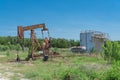 Working pump jack pumping crude oil at oil drilling site in rural USA Royalty Free Stock Photo