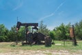 Working pump jack pumping crude oil at oil drilling site in rural USA Royalty Free Stock Photo