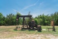 Working pump jack pumping crude oil at oil drilling site in rural USA Royalty Free Stock Photo
