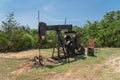 Working pump jack pumping crude oil at oil drilling site in rural USA Royalty Free Stock Photo