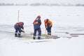 Sailors work at the lane with a fenced wooden formwork Royalty Free Stock Photo