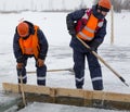 Sailors work at the lane with a fenced wooden formwork Royalty Free Stock Photo