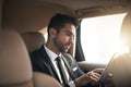 Working remotely. a handsome young businessman using a tablet while on his morning commute to work. Royalty Free Stock Photo