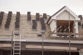 working on the roof sheeting and outriggers or ladder of a new, two story, commercial apartment building Royalty Free Stock Photo