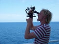 Working with sextant on board of merchant ship at noon time