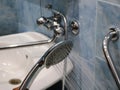 Working shower on the background of the bathroom interior